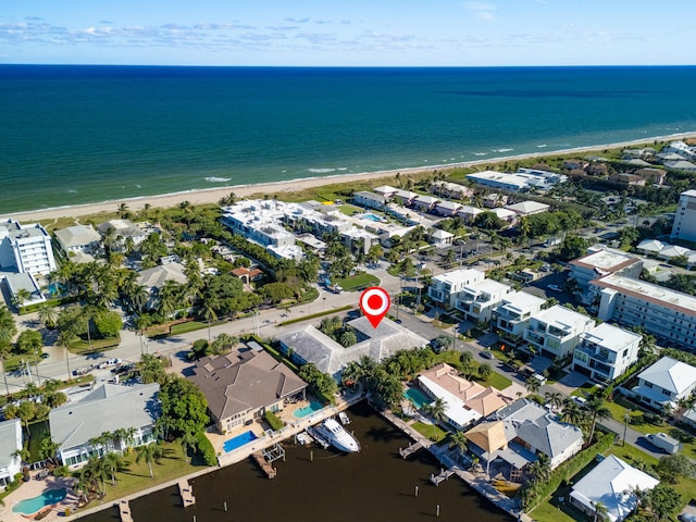 drone / aerial view with a water view and a view of the beach