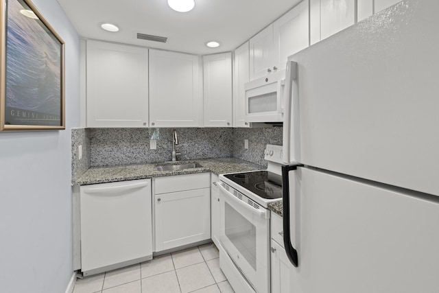 kitchen with backsplash, sink, white cabinets, and white appliances