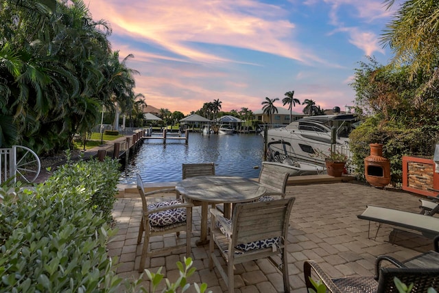 exterior space with a water view and a boat dock