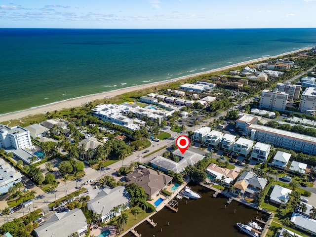 drone / aerial view with a water view and a view of the beach