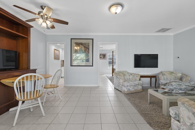 tiled living room with ornamental molding and ceiling fan