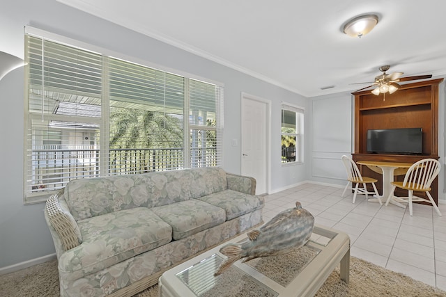 living room with ornamental molding, ceiling fan, and light tile patterned floors