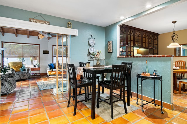 tiled dining space with beam ceiling