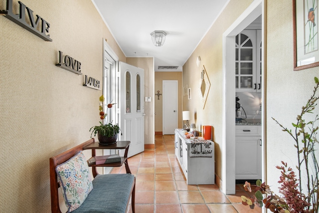 hall featuring light tile patterned flooring