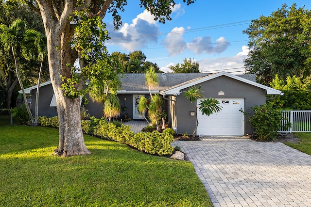 single story home featuring a front yard and a garage