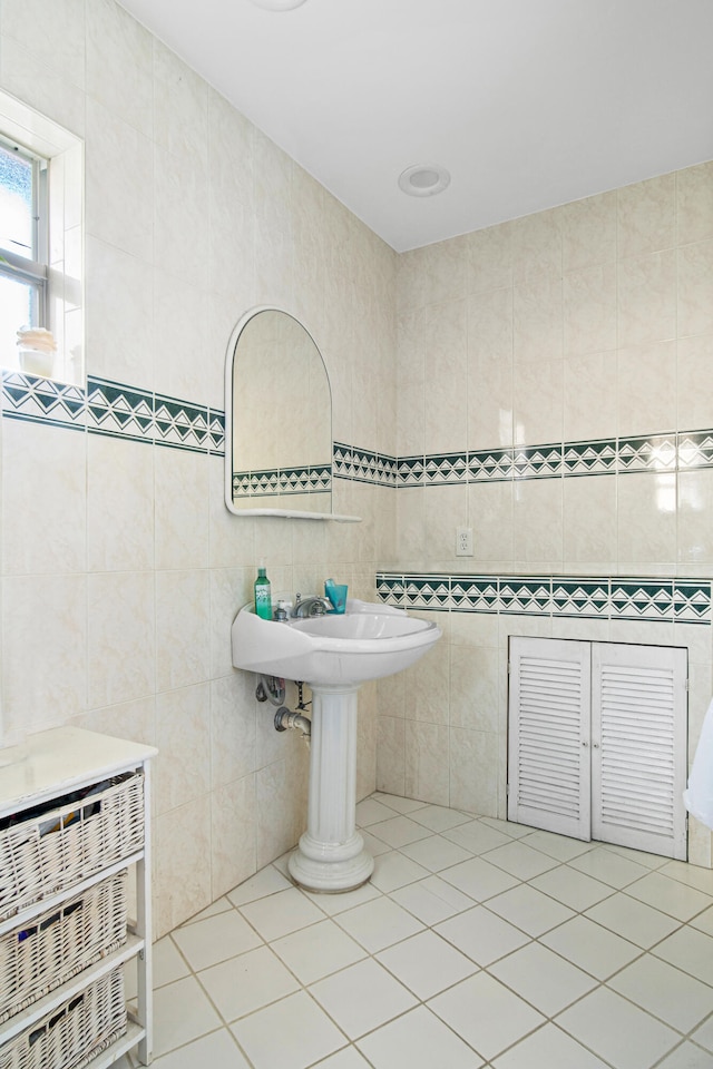 bathroom with tile walls and tile patterned flooring