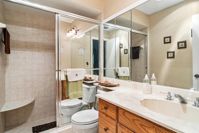 bathroom featuring vanity, toilet, walk in shower, and tile patterned flooring