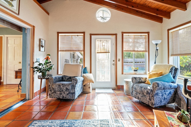 living area featuring lofted ceiling with beams, tile patterned flooring, wooden ceiling, and plenty of natural light