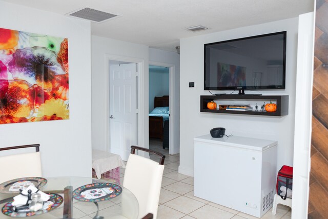 dining space featuring light tile patterned flooring