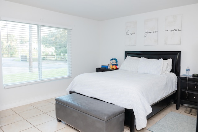 bedroom featuring multiple windows and light tile patterned flooring