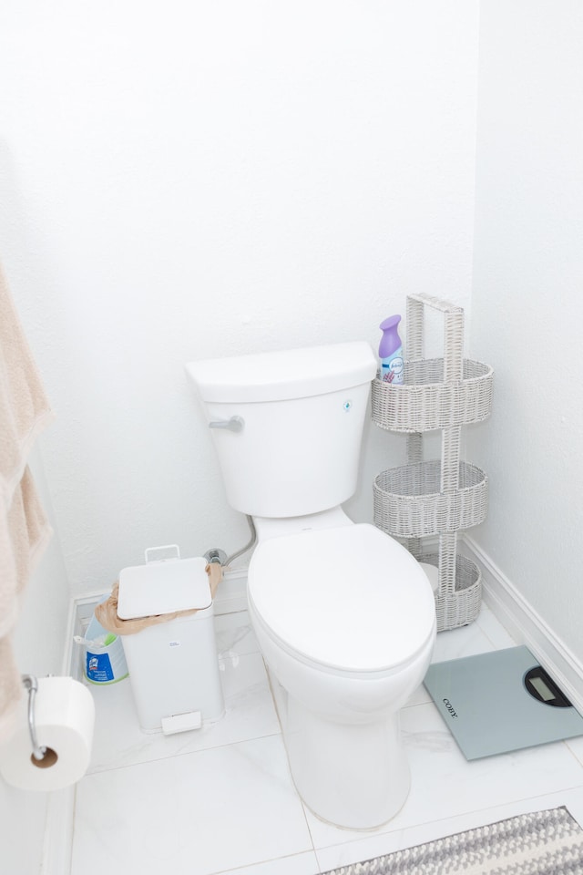 bathroom with toilet and tile patterned flooring