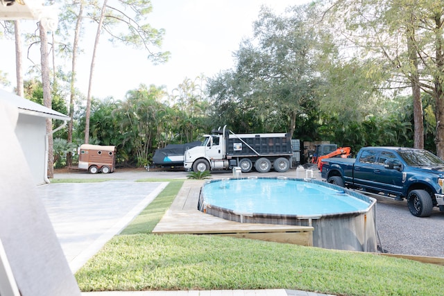 view of pool featuring a lawn