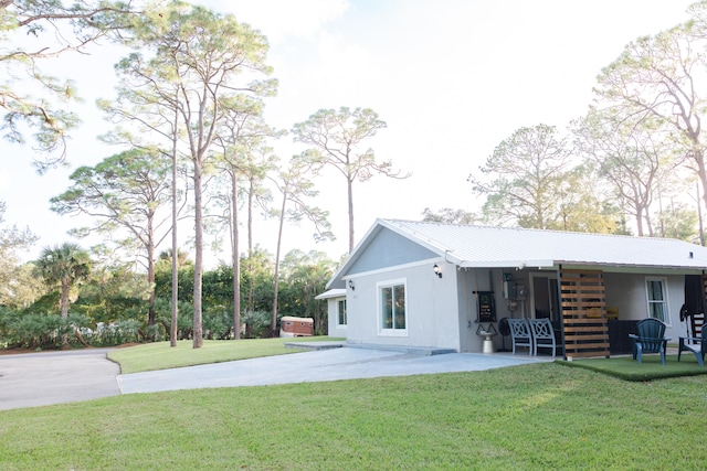 rear view of property with a lawn