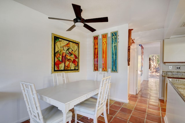 tiled dining room with ceiling fan