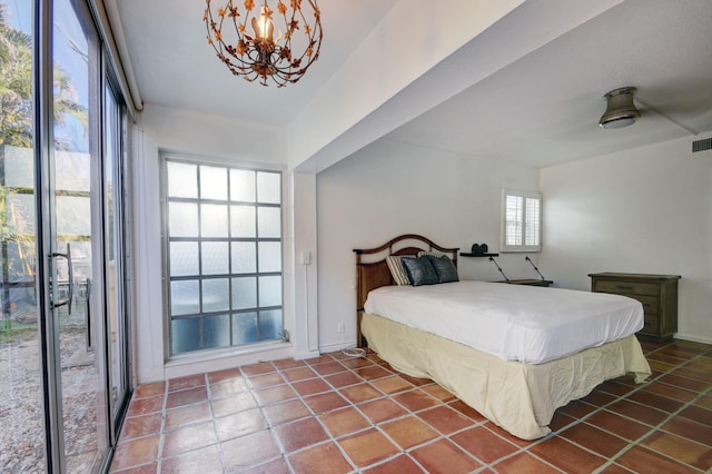 bedroom featuring tile patterned floors, ceiling fan with notable chandelier, and access to exterior