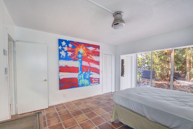 bedroom featuring a closet, access to outside, and a textured ceiling