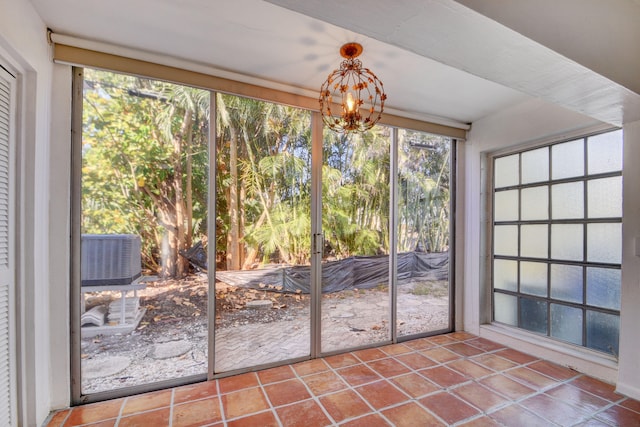 unfurnished sunroom featuring a notable chandelier