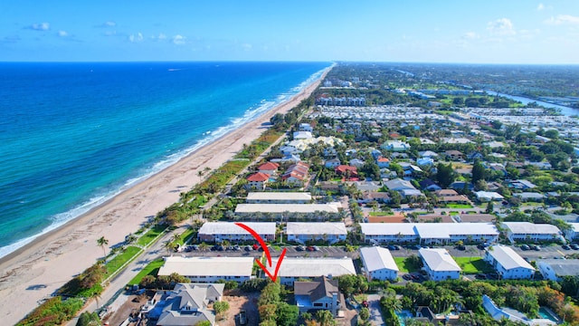 bird's eye view with a water view and a beach view