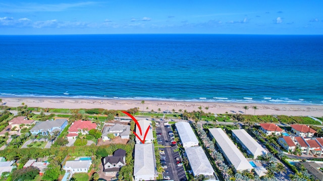 birds eye view of property with a water view and a view of the beach