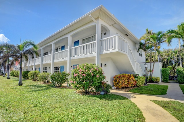 exterior space with a yard and a balcony