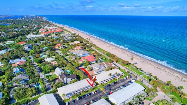 birds eye view of property featuring a water view and a beach view