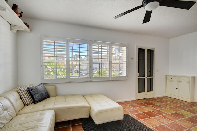 living room with tile patterned floors, a textured ceiling, and ceiling fan