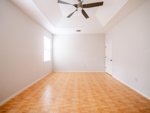 spare room featuring ceiling fan and light tile patterned flooring