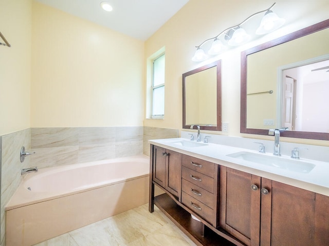 bathroom with vanity and a tub