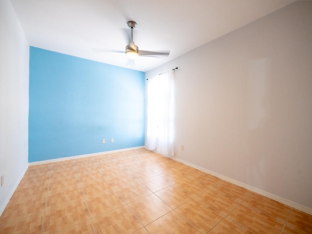 tiled spare room featuring ceiling fan