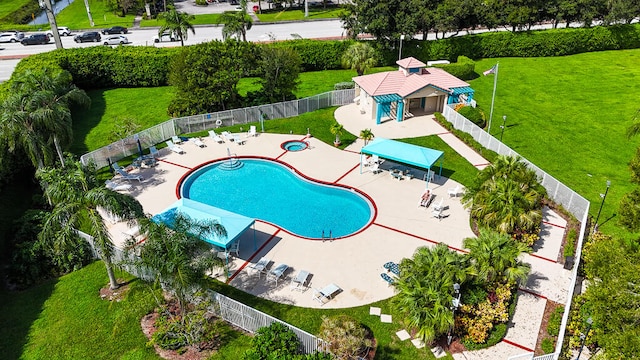 view of pool with a patio area and a lawn