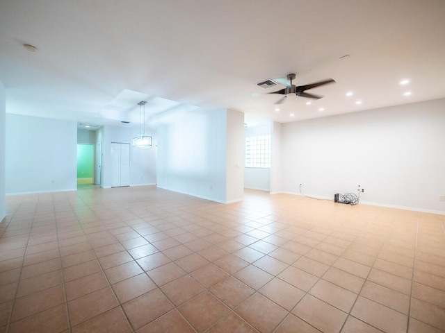 unfurnished room with light tile patterned floors and ceiling fan