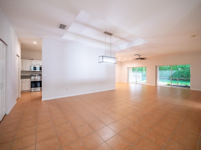 empty room featuring ceiling fan and light tile patterned floors