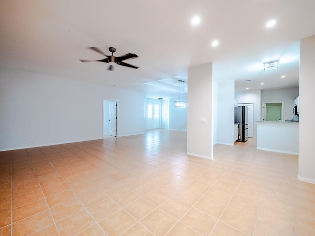 unfurnished room featuring ceiling fan and light tile patterned flooring