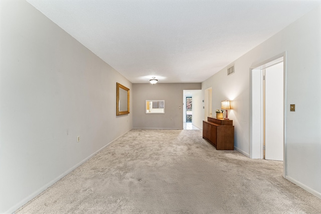 empty room featuring light colored carpet