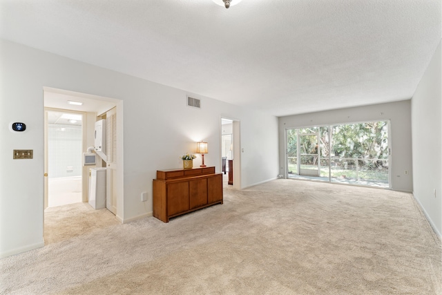 carpeted living room with a textured ceiling