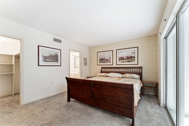 carpeted bedroom featuring ensuite bathroom