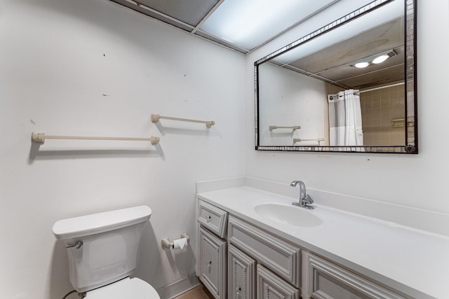 bathroom with toilet, walk in shower, and vanity