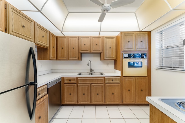 kitchen featuring sink, appliances with stainless steel finishes, light tile patterned flooring, and ceiling fan