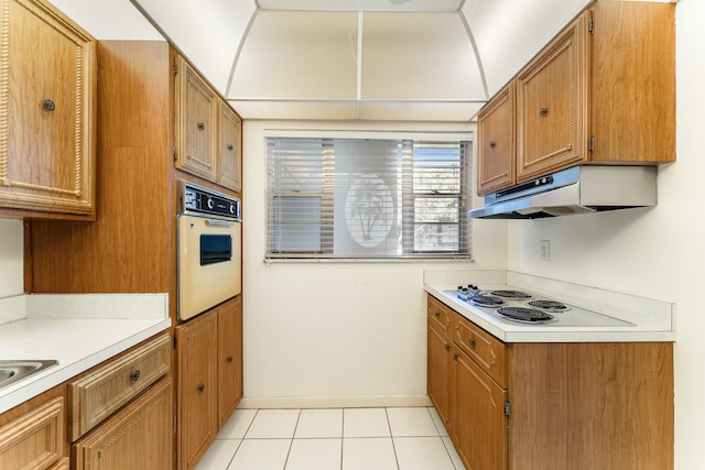 kitchen featuring white appliances and light tile patterned floors