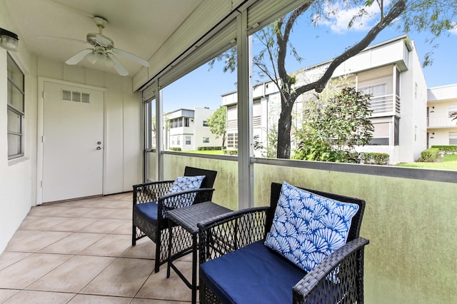 sunroom featuring ceiling fan