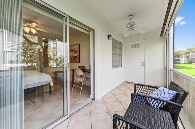 sunroom / solarium featuring ceiling fan