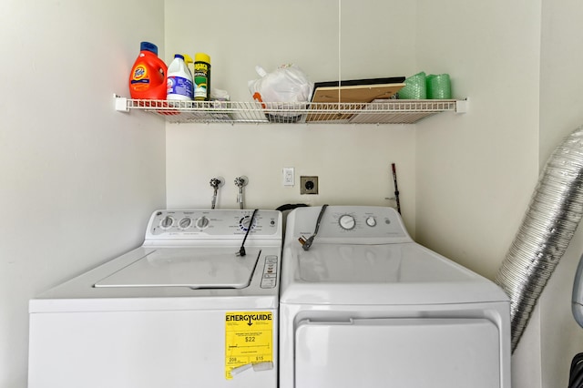 clothes washing area with separate washer and dryer