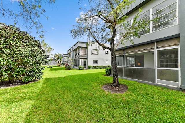 view of yard with a sunroom