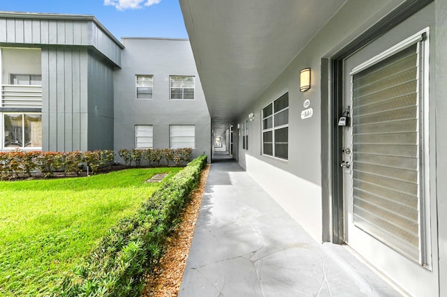 property entrance with a lawn