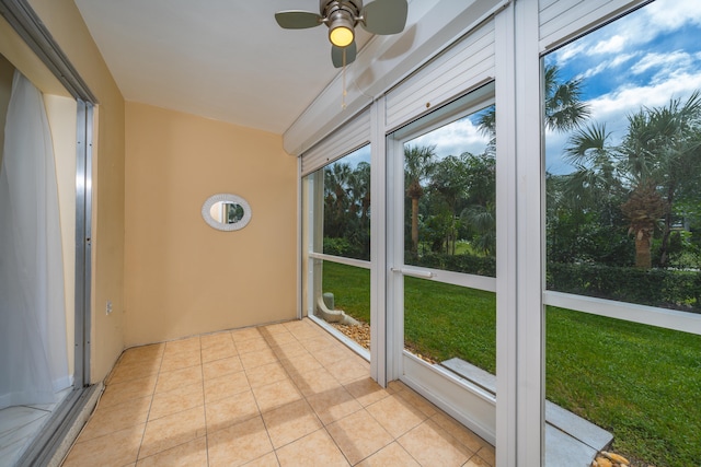 unfurnished sunroom with ceiling fan