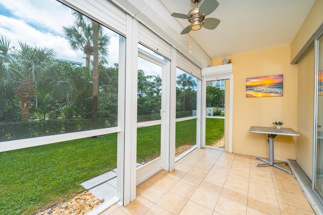 unfurnished sunroom with ceiling fan