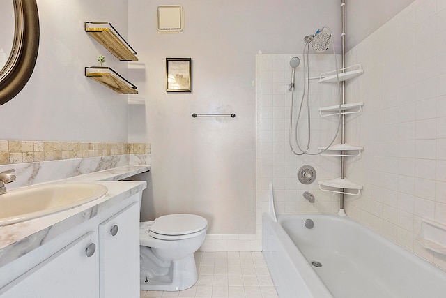 full bathroom with vanity, toilet, tile patterned floors, and tiled shower / bath combo