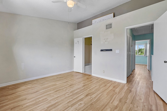 unfurnished room with light hardwood / wood-style floors, a textured ceiling, and ceiling fan