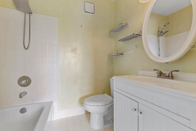 full bathroom featuring vanity, tile patterned floors, tiled shower / bath, and toilet