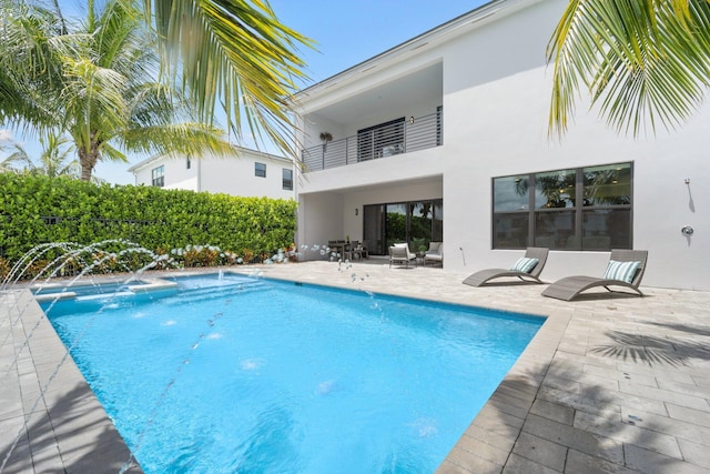 view of pool with pool water feature and a patio area